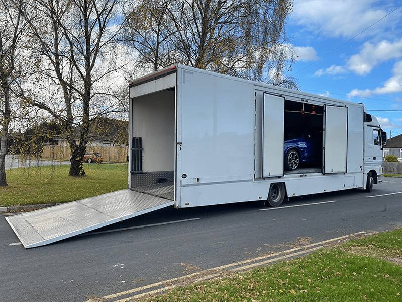 Enclosed car transport trailer with its ramp down